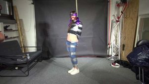 Poor Marie bound and gagged in a shiny nylon Windbreaker