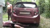 Mistress Jenna stands on the slave with a car while smoking in the slave's mouth B