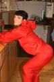 Jill posing in a bar wearing a sexy red rainwear combination with nothing under it (Pics)