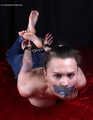 Tapegagged topless barefoot Peggy, hogcuffed with heavy steel cuffs