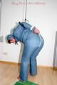 Jill tied, gagged and hooded wearing a shiny blue downwear (Pics)