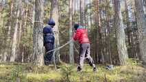 Sebastien breathplay tied up in a puffer jacket among the trees.
