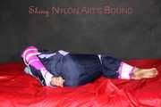 Watching Pia wearing blue/pink shiny nylon rainwear being tied and gagged and hooded with tape and a clothgag (Pics)
