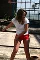 Stella posing outdoor wearing a supersexy red shiny nylon shorts and a white top (Pics)