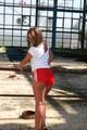 Stella posing outdoor wearing a supersexy red shiny nylon shorts and a white top (Pics)