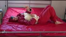 Watching sexy Mara during a photo shooting wearing a sexy red shiny nylon rainpant and an oldschool red/white shiny nylon down jacket posing infront of the camera (Video)