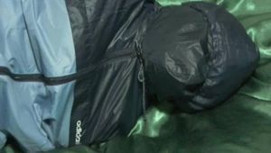 0055 min video with an beautiful archive girl in blue rainwear double hooded, tied and gagged in bed