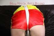 Sexy Lucy tied an gagged with ropes and a cloth gag wearing a super hot red shiny nylon shorts and a yellow rain jacket (Pics)