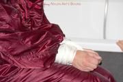 Isabelle tied and gagged in a shiny downwear