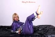 Pia bound and gagged on bed in a shiny purple/silver PVC sauna suit (Pics)