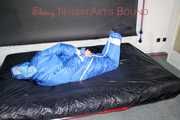 Lucy wearing sexy lightblue downwear tied and gagged with ropes and cloth gag on a bed (Pics)