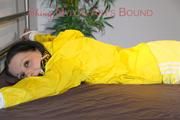Lucy tied and gagged on bedposts face-down position wearing a sexy yellow shiny nylon shorts and a yellow rain jacket (Pics)