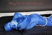 Lucy wearing sexy lightblue downwear tied and gagged with ropes and cloth gag on a bed (Pics)
