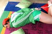 Jill tied and gagged on the floor wearing a hot green shiny nylon shorts and a rain jacket (Pics)