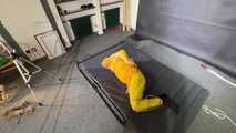 Ms Ungeniert tied and gagged in shiny nylon Rainwear trying to escape