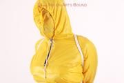 Jill tied and gagged in a shiny yellow rainsuit and rubber boots