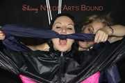 Sexy Mara tied, gagged and hooded overhead on hands and feet with ropes and a cloth gag wearing a sexy black/pink rainwear combination (Pics)