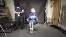 Alice bound and gagged in a shiny nylon Downjacket