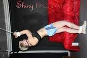 Watching ***NEW MODELL COURTNEY*** wearing a sexy lightblue shiny nylon shorts and a black top being tied and gagged overhead with ropes and a ballgag (Pics)