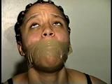 18 Yr OLD STUDENT SHANNA IS WRAP TAPE GAGGED, DUCT TAPE TIED, BAREFOOT, TOE-TIED, HANDCUFFED, MOUTH STUFFED, HANDGAGGED WHILE SITTING ON THE BED (D67-15)