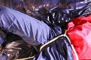 Sonja tied, gagged and hooded on bed with cuffs, chains and a gag wearing a sexy blue shiny nylon rain pants and a red rain jacket (Pics)