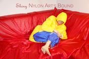 Sonja tied, gagged and hooded on a sofa wearing a sexy blue rain pants and a yellow downwear jacket (Pics)