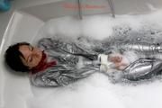 Simone in an shiny grey pvc sauna suit tied and gagged by Sophie in the bath tub (pics)