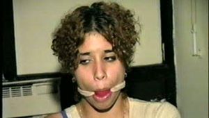 SWEET LATINA MARIE IS BALL-GAGGED, OTM-GAGGED, WRISTS-GAGGED, CLEAVE-GAGGED, MOUTH STUFFED & HANDGAGGED (D48-4)