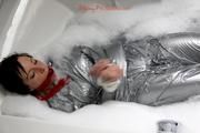 Simone in an shiny grey pvc sauna suit tied and gagged by Sophie in the bath tub (pics)