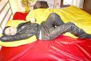 Lucy preparing her bed and enjoys it wearing sexy black rainwear (Pics)