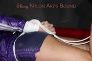 Sexy Pia being tied and gagged with ropes and a clothgag on a bed wearing a sexy darkblue shiny nylon shorts and a sexy blue/purple rain jacket (Pics)