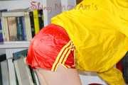 Lucy wearing a sexy red shiny nylon shorts and a yellow rain jacket preparing the sofa to lay down (Pics)