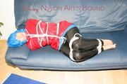 Jill tied, gagged and hooded on the sofa wearing a sexy black shiny nylon pants and two rain jackets (Pics)