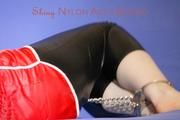 Mara ties and gagges herself with hand cuffs on a sofa wearing a supersexy black Leggings and a shiny nylon shorts and a rain jacket (Pics)