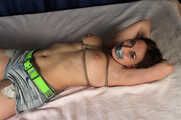 Tapegagged topless barefoot Bianca in jeans shorts, tied on the bed with her legs wide-spread, wiggles helplessly