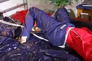 Sonja tied, gagged and hooded on bed with cuffs, chains and a gag wearing a sexy blue shiny nylon rain pants and a red rain jacket (Pics)