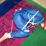 one of our archive girls tied and gagged in a shiny nylon rainsuit