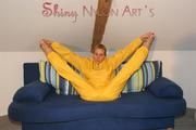 Sexy blonde archive girl posing and lolling on a sofa wearing sexy yellow rainwear over nothing (Pics)