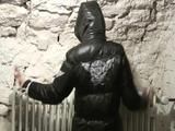 Archive girl tied, gagged and hooded in a cellar wearing a shiny black downcoat (Video)