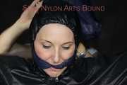 Sexy Mara tied, gagged and hooded overhead on hands and feet with ropes and a cloth gag wearing a sexy black/pink rainwear combination (Pics)