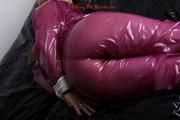 Sophie in an shiny transparent purple PVC suit tied and gagged in bed (Pics)