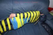 Katharina taped and gagged in a blue nylon rainsuit