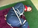 01:00 Min. video with an archive girl tied and gagged in shiny nylon rainwear