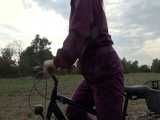 Get a Video with Sandra riding her bike enjoying her shiny nylon Rainwear