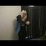 Blonde archive girl put bedding on wearing sexy shiny nylon rainwear (Video)