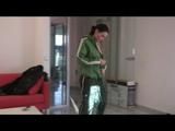 Enni with black shiny nylon shorts and rain pants and a rain jacket over naked skin smoking a cigarette (Video)