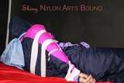 Watching Pia wearing blue/pink shiny nylon rainwear being tied and gagged and hooded with tape and a clothgag (Pics)