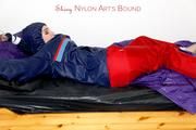 Jill tied and gagged in shiny nylon rainware