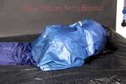 Lucy tied with cuffs overhead and gagged with a clothgag wearing sexy blue rain pants and a raincoat (Pics)