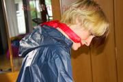Sonja tied and gagged standing on a chair wearing a sexy red shiny nylon shorts and a darkblue rain jacket (Pics)